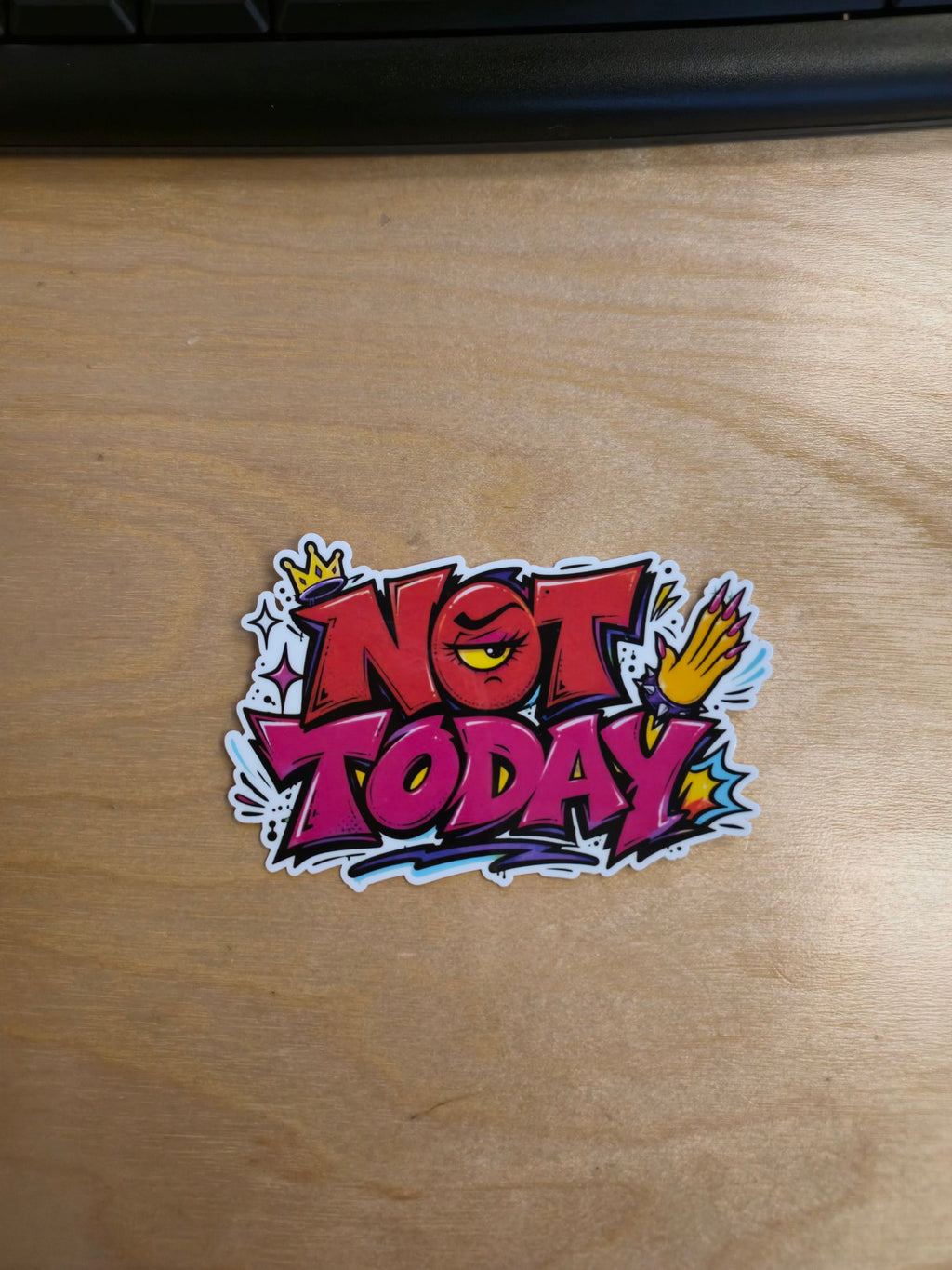 "Not today" graffiti-style vinyl sticker on desk
