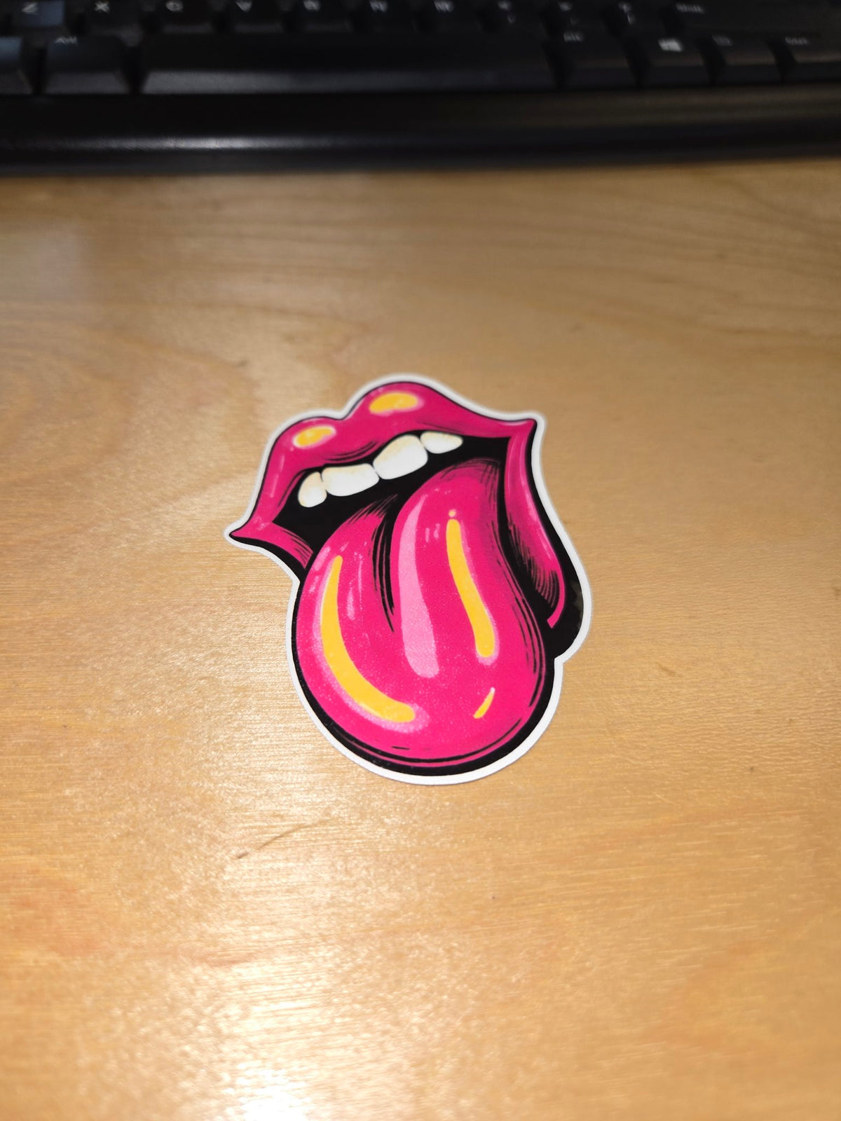 Pink lips and tongue vinyl sticker on desk